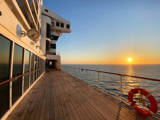 View from open decks of legendary luxury ocean liner  cruise ship on sunny day twilight sunset...