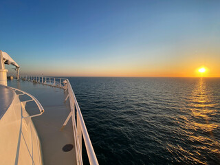 View from open decks of legendary luxury ocean liner  cruise ship on sunny day twilight sunset...