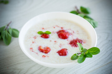 sweet milk oatmeal with strawberries in a plate