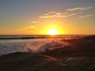 Fototapeta na wymiar water sun cloud sky sea sunset beach wave rock stone morning clouds