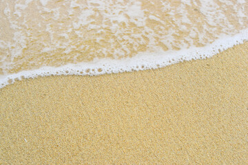 Soft sea waves on the beach wet the beautiful white sand