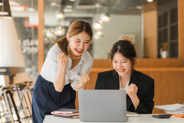 Portrait of Asian young female working on laptop at office