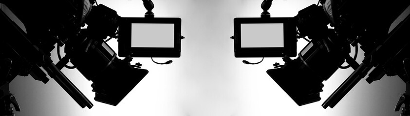Silhouette images of video camera in tv commercial studio production which operating or shooting by...