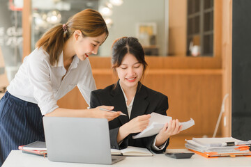 Portrait of Asian young female working on laptop at office