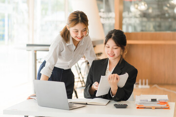 Portrait of Asian young female working on laptop at office