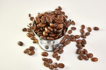 Metal bucket with roasted coffee beans.