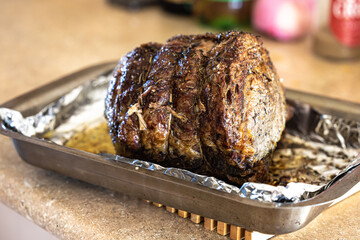 A large prime rib beef roast that was baked and roasted in the oven by a home gourmet chef for a holiday Christmas dinner