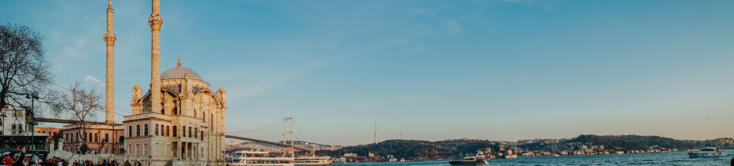Panorama view of the Ortakoy Mosque and Boğaziçi Köprüsü in Istanbul during the Sunset. 