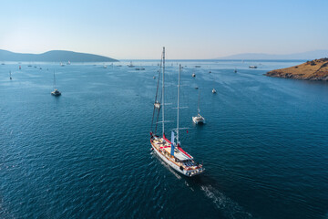 Aerial view of a white yacht crossing Bodrum Harbor, Turkey