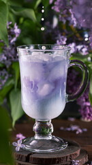 milkshake from anchang. Blue milkshake among lilac flowers.