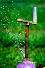 Farm Field Sprinkler Pipe with Leaky Valve Water Leaking Spraying from Leak