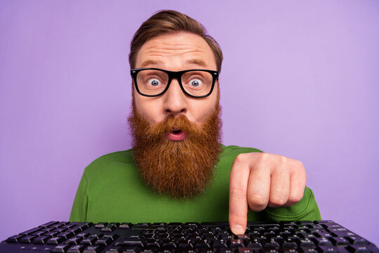 Portrait of attractive freelancer man press button on keyboard improving system hardware isolated on violet color background