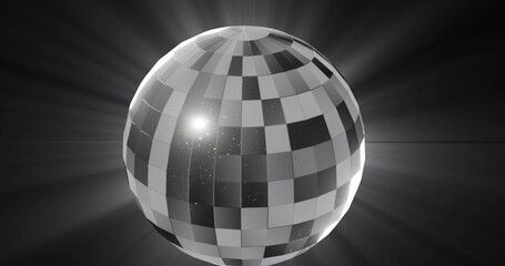 Image of monochrome rotating mirrorball and lights on black background