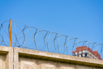 Fototapeta premium Barbed wire in the prison. Restriction of freedom.