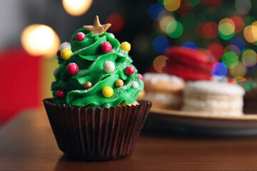 Christmas tree shaped cupcake on wooden table indoors, closeup. Space for text