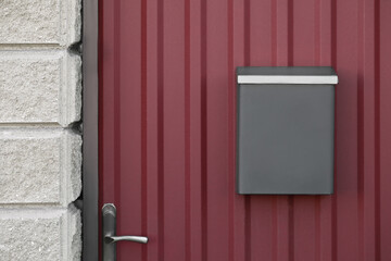 Black metal letter box on door outdoors