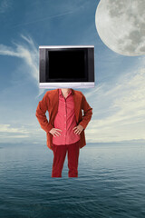 Contemporary art collage. Man in red suit with TV head standing alone in the middle of the ocean....