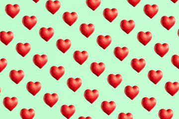 Red hearts pattern against pale green background. Love and passion. 