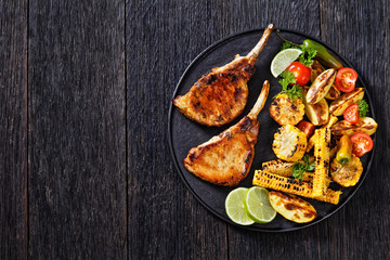 bbq tomahawk pork chop with corn and potatoes