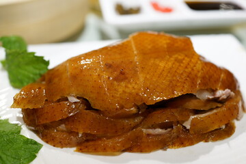 Beijing roasted sliced duck dinner on white plate with sides