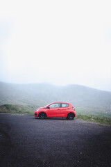 Red car in nature with fog, Azores