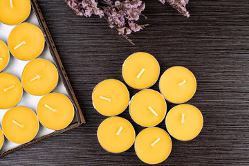 Romantic composition of aromatic candles on a dark background, top view, flat lay.