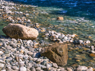 A mountain river with clear and transparent water. Landscape with a view of gray stones in a mountain river. Clean water and healthy water.