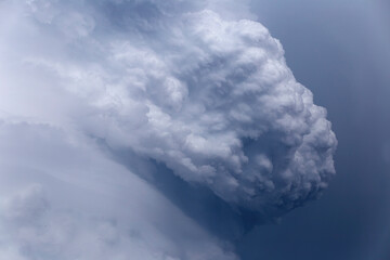 puffs of rain clouds swirling into a whirlwind, before a thunderstorm