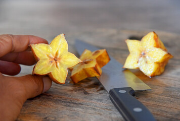 Rotten star fruit,over ripe fruit,in yellow color,placed on brown wooden table