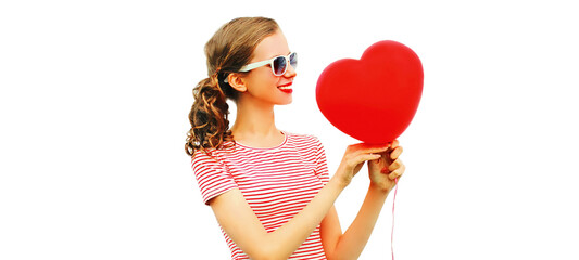 Portrait of happy smiling young woman holding red heart shaped balloon isolated on white background