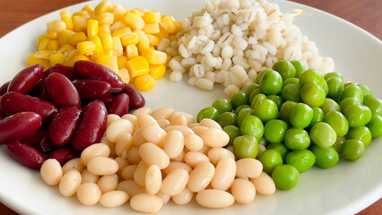 top view of navy bean and red bean and corn and  green peas and millet in white plate on wood background - 508478687