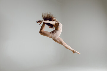 Young woman contemporary ballet dancer dancing high heels dance jumping leg split ballerina