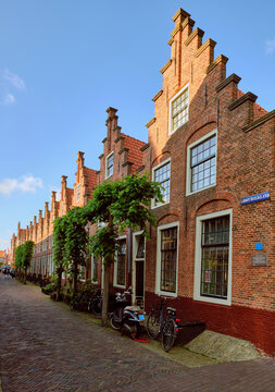 Haarlem, Netherlands - MAY 24, 2022: Row of houses with stepped gables in Groot Heiligland street in old town. Diminishing perpsective.
