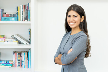 Pretty hispanic businesswoman with crossed arms