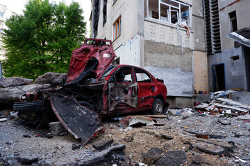 Consequences of the war in Ukraine, destroyed houses and burned cars. Cars of civilians were shot and burned. War of Russia against Ukraine. Cars damaged after shelling. Kharkov, Ukraine. War crimes