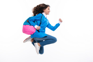 Schoolgirl in school uniform with backpack. Teenage girl student on white isolated background. Run...