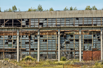 abandoned industrial building with broken windows, exterior view