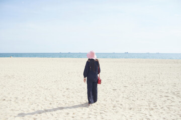 A woman walking on the beach
