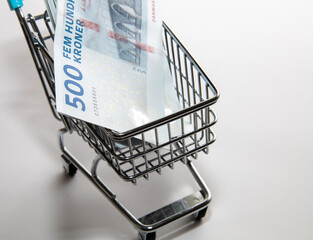 Money of Denmark. Danish kroner bills and supermarket shopping cart. DKK banknotes. 500 kroner....