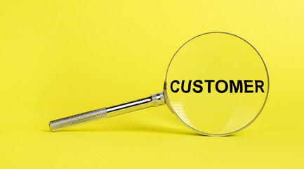 Magnifying glass with word customer on yellow background. Exploring clients, consumers attitudes,...
