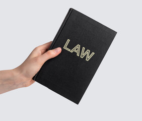 Woman hand with law book. Code, legal dictionary, guide. Education, studying information for becoming lawyer concept. Literature for attorney work. High quality photo