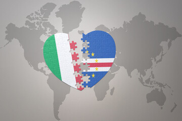 puzzle heart with the national flag of cape verde and italy on a world map background. Concept.