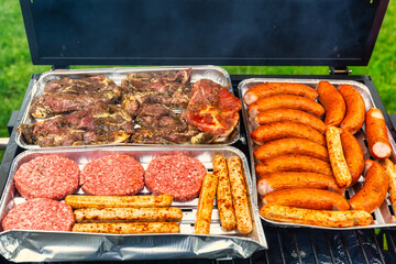 Meat, susages and burgers grilled on the garden barbeque
