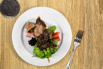 Roast barbecue sliced on white plate. Beef veal steak with vegetable on a plate. Top view.