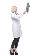 qualified female doctor looking at an x-ray .