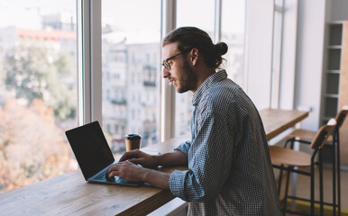 Caucasian businessman work at windowsill in office