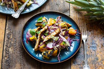 Jamaican jerk spicy chicken, grilled pineapple and red cabbage salad
