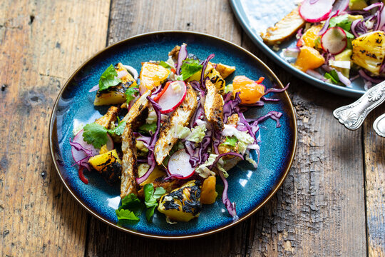 Jamaican jerk spicy chicken, grilled pineapple and red cabbage salad