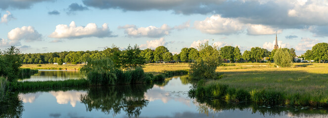 Panorama of Markdal nature reserve nearby the city of Breda, view of River Mark and the church of...