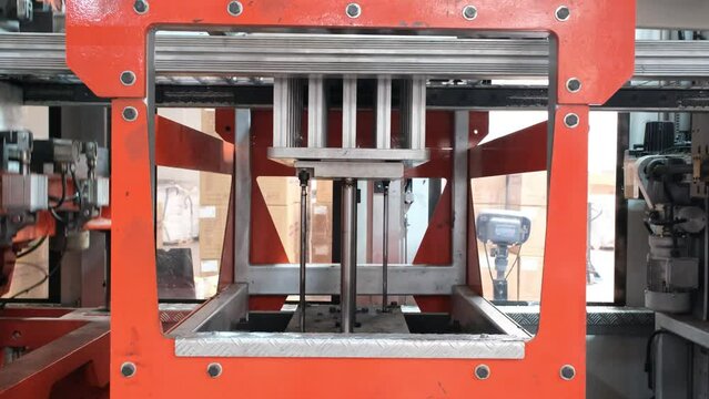 Vacuum thermoforming machine is used for producing plastic packaging in the factory. Close-up of the machine making a mold.